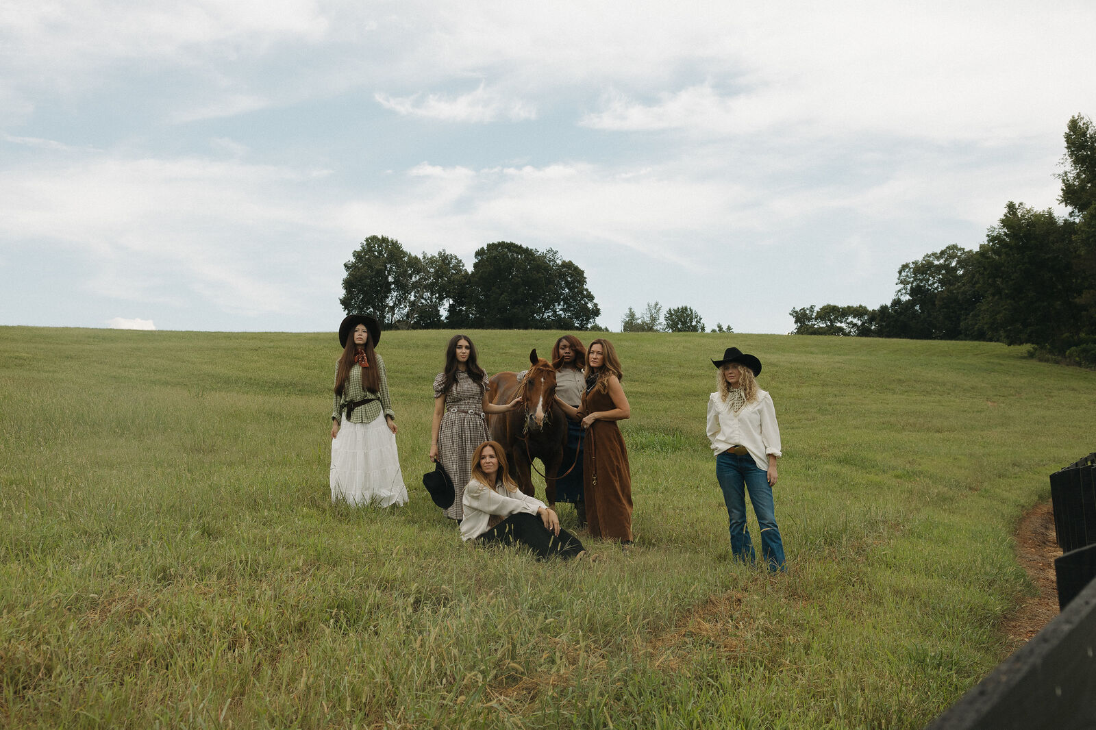 A group of women gathered in a field